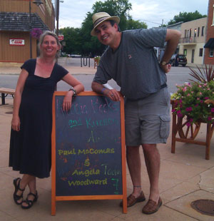 A smilin' Angela & Paul flank the store's psychedleic chalkboard.