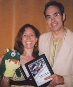 Paul, Heather, and "Gorzak" monster-puppet accept their award