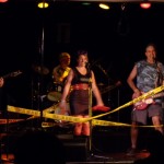 Yellow police tape covers the stage as the Taste Oilers rock out.