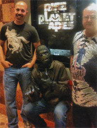Frank and Robert flank "gorilla Paul" in from of the Rise movie poster.